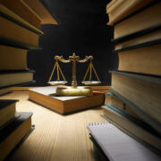 stack of books and libra scale