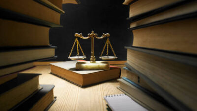 stack of books and libra scale